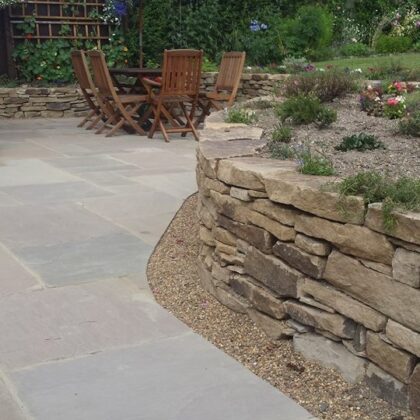 stone retaining wall with beautiful patio