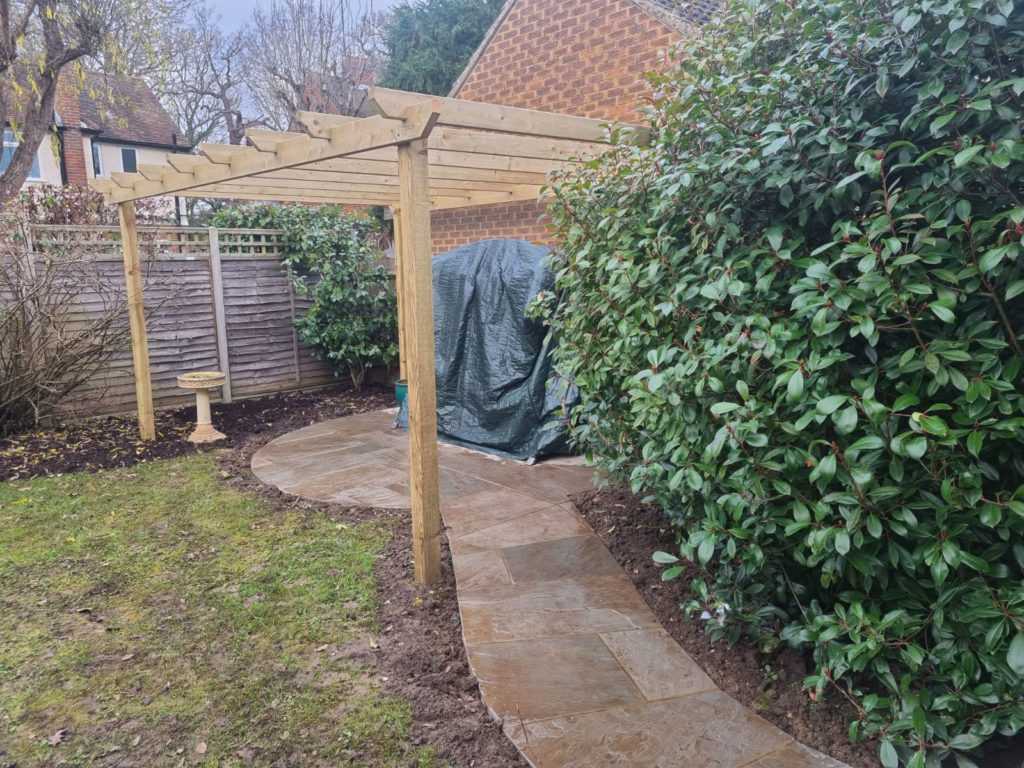 beautiful garden pergola with stone path and hot tub. Inspecting this structure is on our list of gardening jobs for spring