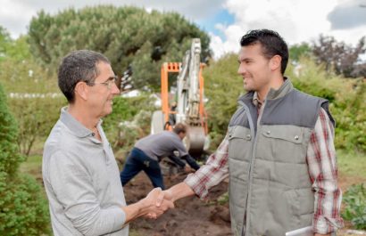 client shaking hands with a reputable landscaper